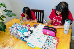 Alyssa and Kayla make care packages for the homeless
