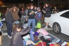 Streets of Hope volunteer, Parker, helps organize the clothing donations.