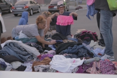 A few homeless woman sort through the many clothing donations this Memorial Day.