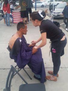 Praying with downtown San Diego homeless man after cutting his hair.