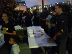 Volunteer Nate helping prepare food trays to feed San Diego's homeless.