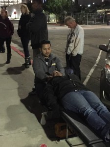 Jeremy, homeless chiropractor, adjusts a homeless man's neck in downtown San Diego.