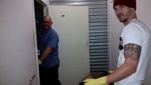 Eric and Joe cleaning out the dirt and muck from the homeless storage unit.