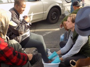Anne washes a homeless woman's feet on the streets of downtown San Diego.