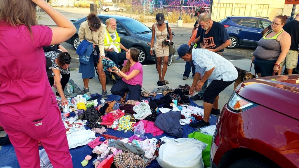 Some downtown San Diego's homeless receiving clothing, blanks and toiletries donated by Newport