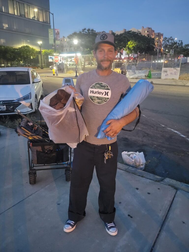 Homeless man Robert receives a tent and a blanket in downtown San Diego on a Monday Night
