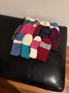 Hand-knit hats from leftover yarn from various projects for the homeless